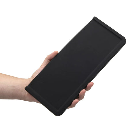 Hand holding Ultra Thick Espresso Tamping Mat For Large 5x12 Inch Coffee Bar Station Silicone Tamper Pad