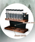 Transform Your Counter Into A Lowkey Essential Coffee Bar With This Badass 2 Tier Organizer Stand Built On Solid Wood And Carbon Steel Frame Holds 12 Airtight Bean Canisters One Way Valves Plus Pour Funnel. Image shows carbon steel frame and solid wood base with canisters.