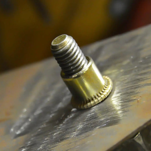Close-up of Carbon Steel Rivet Nuts Threaded Inserts Kit 500 Pcs Galvanized Heavy Duty Fasteners on metal surface