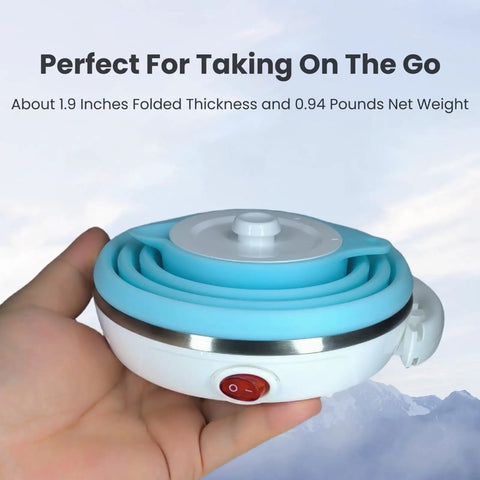 Hand holding a folded Ultra Thin Collapsible Travel Electric Kettle With Auto Shut Off And Keep Warm 110V, 555ml Food Grade Silicone, Blue.
