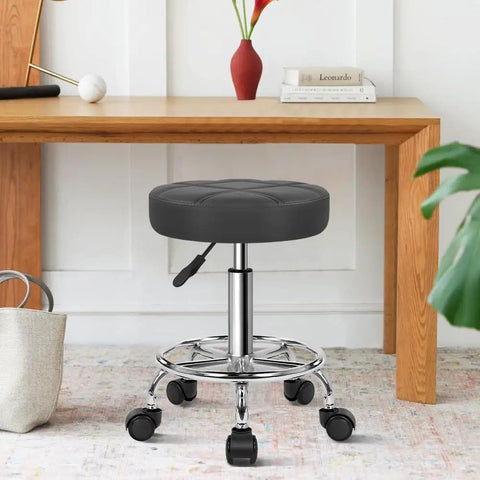 Round Rolling Stool with Footrest and PU Leather Seat Adjustable 360 Degree Swivel Wheels Office Chair in home setting