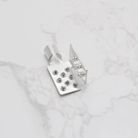 Crimp mounting clamp, silver metal, front view with multiple holes for infrared heating foil installation