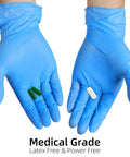 Top Notch Disposable Vinyl Exam Gloves In Steel Blue, Cast At Four Mil Thick For Daily Grind Demands, Zero Latex And Powder, Sharp For Medical Visits Or Quick Kitchen Washes, One Hundred Pack Boxes Ensure Legit Finger Comfort On Every Use, hands wearing gloves holding pills.