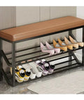 Industrial Entryway Shoe Bench With Seating Two Tier Metal Shoe Rack in Beige and Gold holding various shoes in entryway