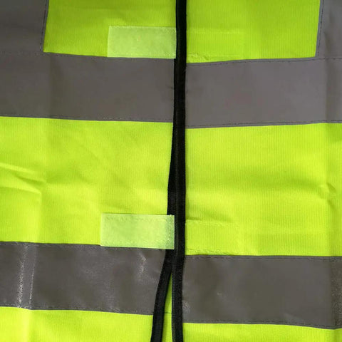 Close-up of Must Have High Visibility Reflective Safety Vest 10 Pack Neon Yellow Gear For Outdoor Work And Play showing material and reflective strips.