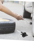 Spare Tire Bolt Retainer Clamp For Trucks And SUVs, Quick Release Hold Down Accessory in use during tire change.