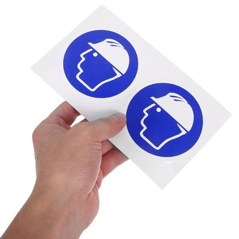 Sheet with two blue hard hat safety stickers held by hand, Hard Hat Safety Stickers For The Job Site Self Adhesive Warning Decals For Machinery