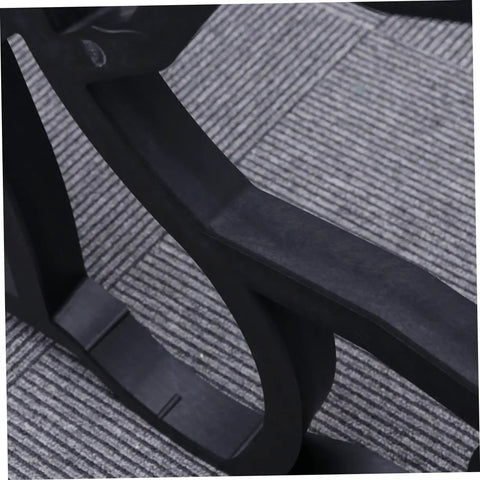 Close-up of black plastic Butterfly Shaped Paving Mold For Garden Paths And Walkways on a gray background surface