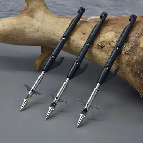 Beefed Up Fishing Darts For Slingshots Package D with barbed tips, three metal and plastic darts on wood background