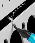 Close-up of a blue-handled deburring tool with curved swivel blade removing burr from metal edge.