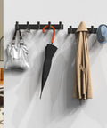 Black Wall Mount Coat Rack With 5 Hooks For Robes, Bags, Towels, Hats And Keys holding various items in a room setting