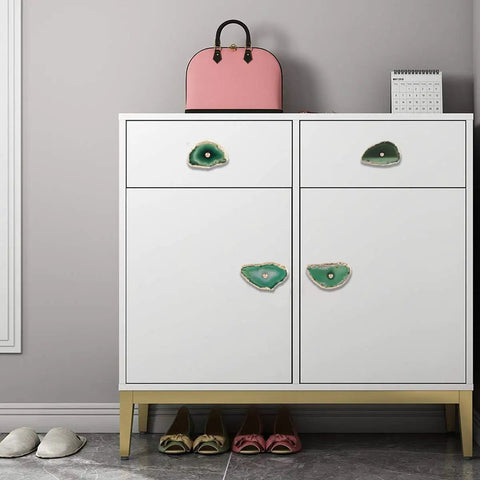 Four Pack Green Agate Slice Cabinet Knobs And Drawer Pulls Featuring Solid Brass Hardware on modern white dresser with pink bag.
