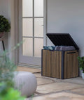 Backyard Must-Have Everwood 30 Gallon Resin Outdoor Storage Box And Patio Side Table opened on patio, holding cushions, walnut finish