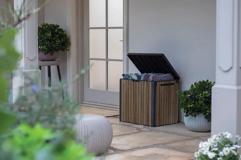 Backyard Must-Have Everwood 30 Gallon Resin Outdoor Storage Box And Patio Side Table opened on patio, holding cushions, walnut finish