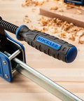 Close-up of Beefy 24-Inch Parallel Bar Clamps For Woodworking with ergonomic handle on a wooden table