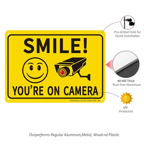 Two Pack Smile Youre On Camera Sign For Outdoor Video Surveillance Signs UV Printed Aluminum 10 By 7 Inches Rust Free For Home And Biz Driveway CCTV Security Signage with smiley face and camera graphics, pre-drilled holes, and UV protection details visible.