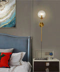Slick Modern Long Globe Plug In Wall Sconce Lights Set Of 2 With Clear Glass Globes Brass Gold Finish in bedroom