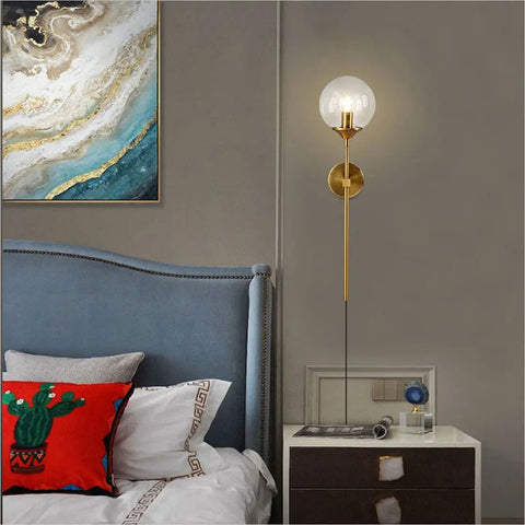 Slick Modern Long Globe Plug In Wall Sconce Lights Set Of 2 With Clear Glass Globes Brass Gold Finish in bedroom