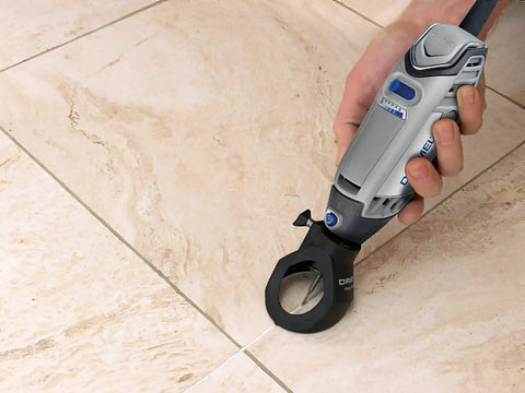 Grout Removal Rotary Tool Attachment For Tile Grout Lines With A 30 Degree Cutting Angle Centered Guides Large Visibility Window And Depth Adjustment To Three Eighths Inch For Wall And Floor Grout By Dremel in use on tile floor