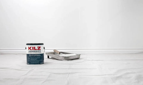 Ultra Bond Adhesion Primer for Interior and Exterior Surfaces, can and paint tray on drop cloth, 1 quart.