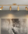 4 Light Gold Finish Flush Mount Ceiling Fixture With Rotating Heads in living room over abstract art, modern track lighting