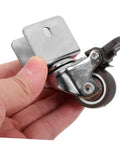 4 Pack Heavy Duty Swivel Casters Rolling Smooth As Silk With Retractable Kickback Locks For Living Room Furniture Workshop Carts And Storage Lockers Rock Solid Setup, close-up of caster wheel in hand.