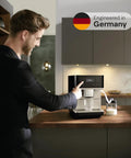 Top Shelf Fully Automatic Coffee And Espresso Maker Featuring Quiet Steel Grinder And Rich Milk Frother, in use on kitchen counter.