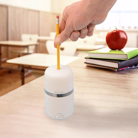 Two In One Battery And Electric Fully Automatic Pencil Sharpener For Regular Graphite And Drawing Pencils With Auto Feed And Auto Eject Adjustable Tip Size Includes AC Adapter Office And School Use White on wooden desk.