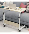 Grab And Go Adjustable Laptop Desk With Smooth Casters Dead Simple Height Tweaks For Living Room Hustle Setup Or Bedside Chill Spot In Modern Matte Black Finish on a sofa.