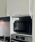 Soft-Close Hydraulic Cabinet Door Hinges with Adjustable Dampers installed on kitchen cabinet above microwave