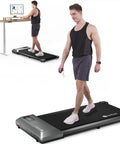 Portable Under Desk Walking Pad Treadmill With Remote And 300 Lb Capacity Hassle Free Setup Compact Home Office Fitness Gear To Clock Up Steps While You Type In Gray, man walking on treadmill next to desk