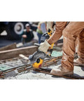 Worker using 9 Inch 5/64 By 7/8 T1 Flexvolt Cutoff Wheel For Metal Cutting on rebar with cordless grinder outdoors