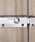 Rock Solid Sliding Bolt Door Lock With Smooth Auto Glide And Flat Barrel Profile For Patios Barn Doors And Gates Super Easy Surface Mount Security Hardware In Matte Silver Finish on wooden door.