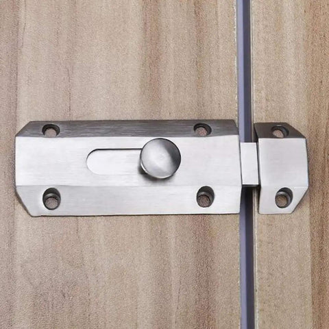 Rock Solid Sliding Bolt Door Lock With Smooth Auto Glide And Flat Barrel Profile For Patios Barn Doors And Gates Super Easy Surface Mount Security Hardware In Matte Silver Finish on wooden door.
