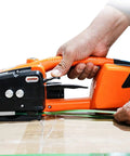 Electric Welding Strapping Machine 13 16Mm Automatic Steel Strap Toner in use sealing a cardboard box with plastic strapping.