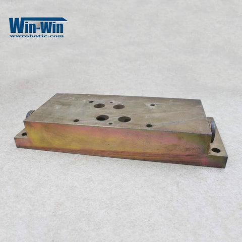 Waterjet hydraulic manifold top-mount, side view; metal block with multiple top holes and mounting holes.