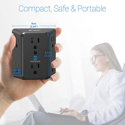 Close-up of black Six Outlet Wall Plug Extender With Surge Protector in hand, 900J protection, showing dimensions, ETL listed, next to woman using laptop.