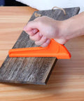 Hand using Bright Orange Safety Push Stick Set For Table Saw And Band Saw Ergonomic Handles 4 Pack on wood board