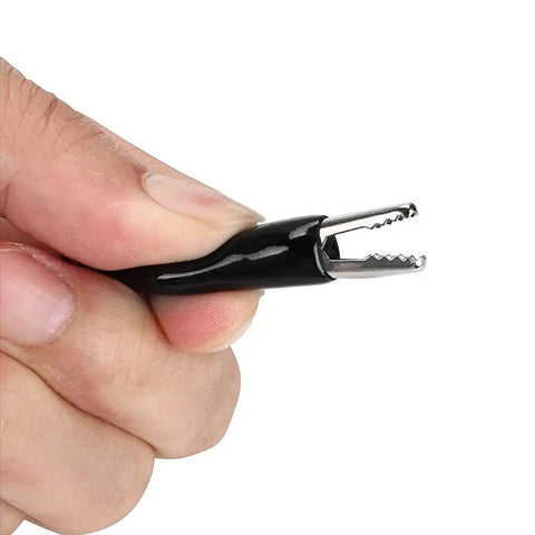 Person holding alligator clip from Stackable Banana Plug To Test Hook And Alligator Clip Leads Kit For Multimeters Flexible Silicone Electrical Test Wires With Protective Sheath Dual Active Pairs For Quick Setup And Reliable Readouts.