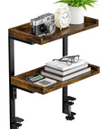 Dope Clamp On Desk Shelf Two Tier Wood Setup For Office Desk And Gaming Accessories 12.5 Inch Tabletop Book Storage Rack Top And Under Desk Organizer No Drill Brown Finish with camera, plant, glasses, books, and clock displayed on shelves.