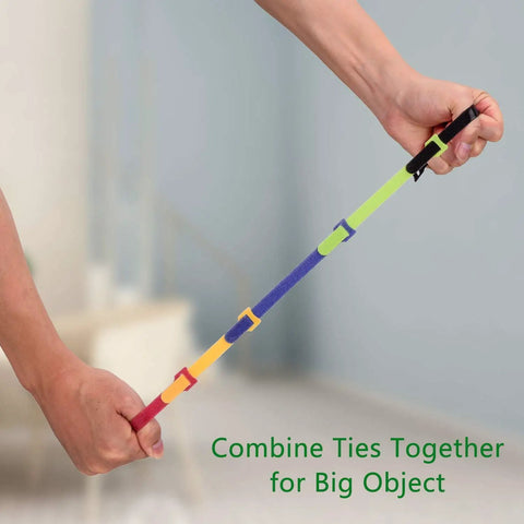 Hands stretching reusable hook and loop cable ties pack 60 count adjustable cable straps, showing smooth wire management.
