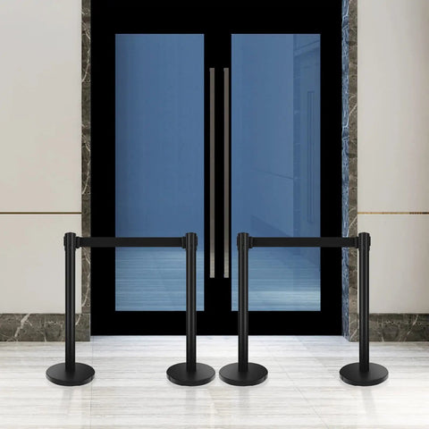 Built Tough Heavy Duty Black Crowd Control Stanchions With Premium Steel, 6.5 Foot Retractable Belt Safety Barriers in front of doors