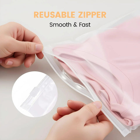 Hands using 50 Pack Clear Zipper Storage Bags 8x10 Inches Waterproof Reusable Travel Organizers for storing clothes.