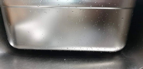 Close-up view of the Stainless Steel Basin Tub Rack for dishwashing and cleaning, showing the rounded rectangle design with water droplets.