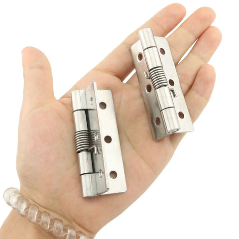 Spring Loaded Hinges For Invisible Doors 304 Stainless Steel Self Closing Hardware shown in hand with 2.5 inch size