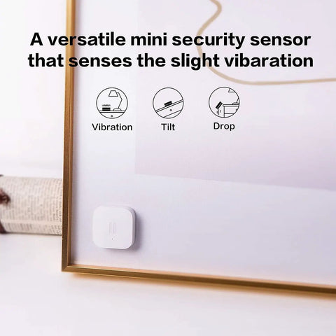 Zigbee Vibration Sensor And Glass Break Detector For Home Security, Wireless Mini Alarm Sensor attached to a picture frame