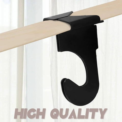Close-up of a black matte finish single hook from a 20 Pcs Metal Drop Ceiling Hooks Set For Hanging And Decor, attached to a T-bar track.