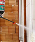 Person using Heavy Duty Class A Fire Rated Spray Foam Insulation Kit with Pro Trigger Gun for wall insulation.