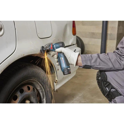 Compact 12 Volt Max Brushless Right Angle Die Grinder With Variable Speed Trigger and Five Speed Options in use on car body with sparks.