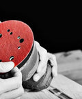 Hook And Lock ROS Sanding Discs For Wood Metal And Plastics 5 Inch 120 Grit held by a person on a sander.